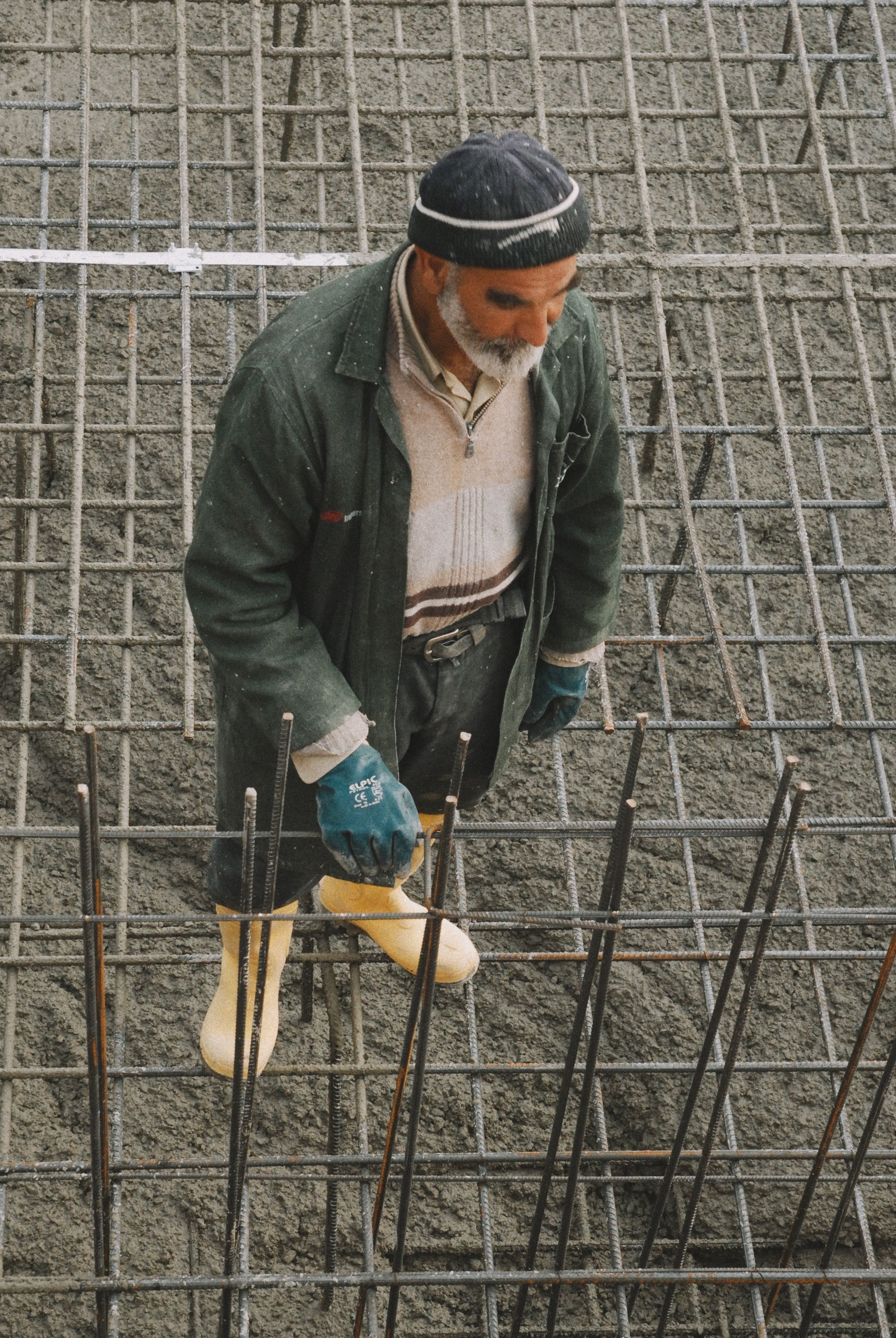 Experienced Structura tradesman tying steel rebar reinforcement before a concrete pour